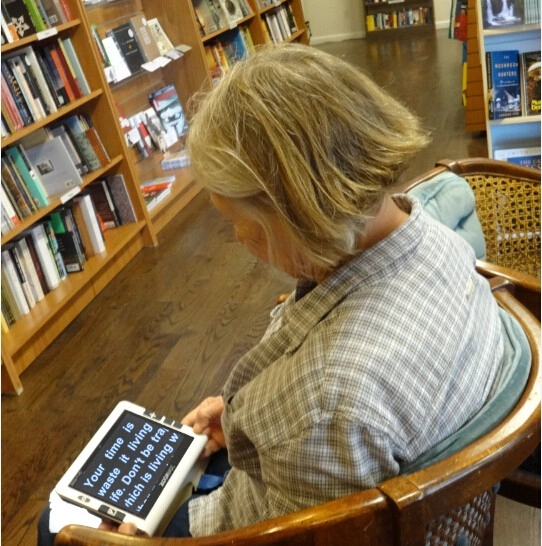 people with vision impaired is using handheld video magnifier snow 7 hd for reading