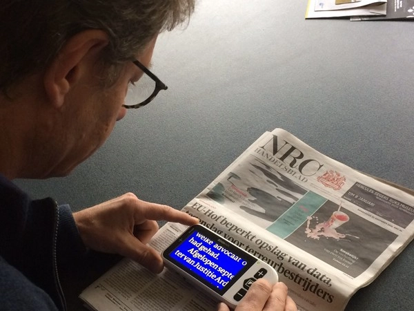robert coppes foundation staff reading dutch paper with zoomax snow 4.3″