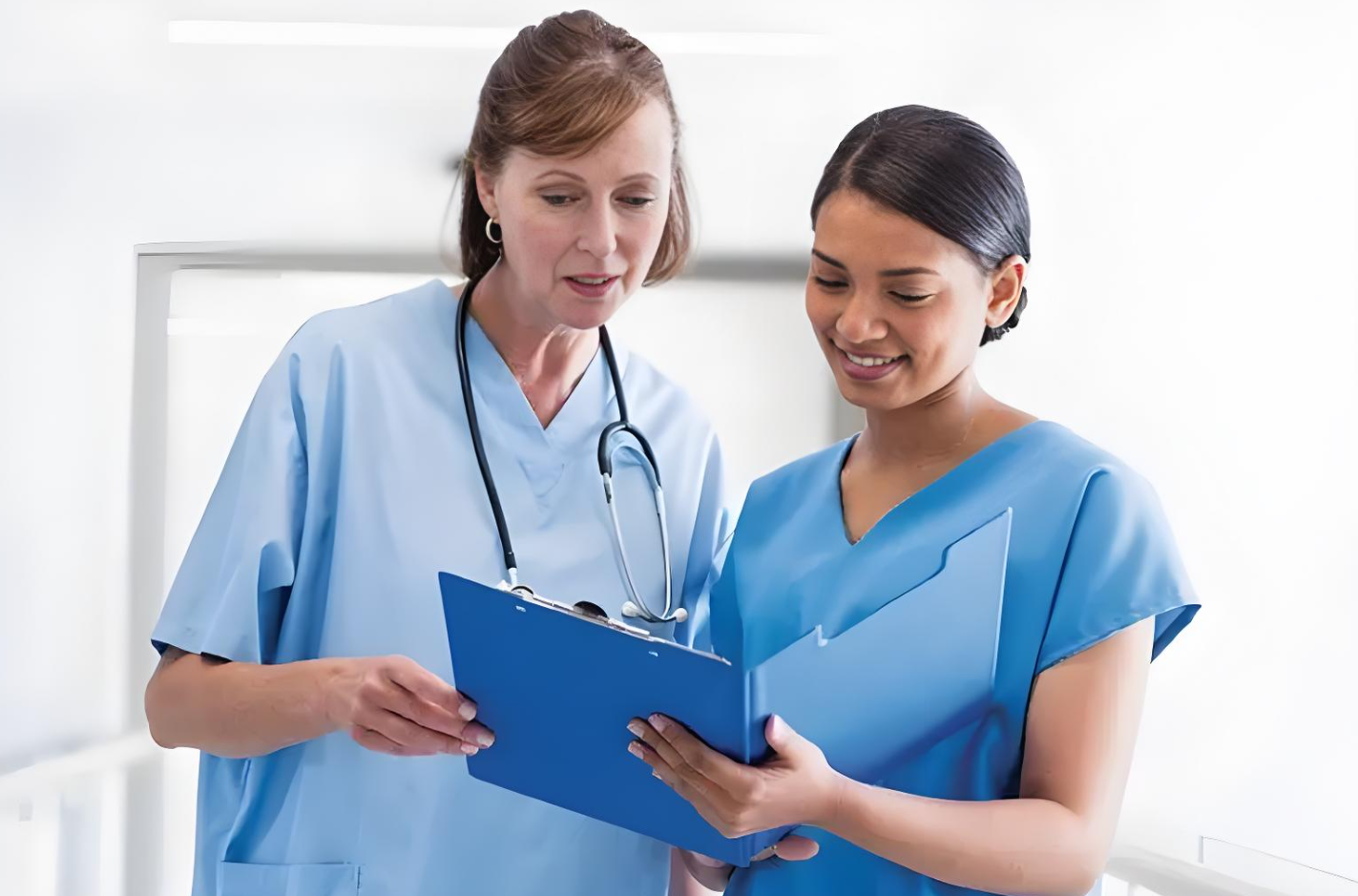 Two medical professionals discussing a patient's care plan, representing the essential role of hospitals and medical centers in diagnosing and managing conditions that cause low vision. This support includes providing treatments, visual aids, and rehabilitation services such as vision therapy and occupational therapy.