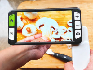 low vision people uses zoomax luna 6 electronic magnifier to check if mushrooms are sliced evenly