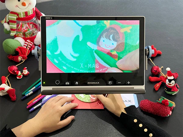 low vision person making cards with snow12 for christmas 2025