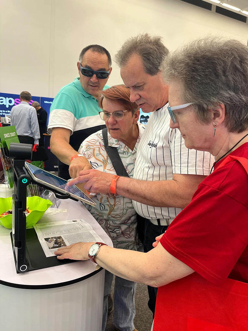 zoomax team demoing low vision magnifiers at sightcity frankfurt booth 2
