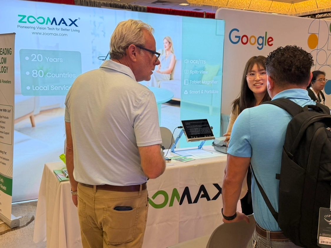 visitors exploring the zoomax booth at csun 2026