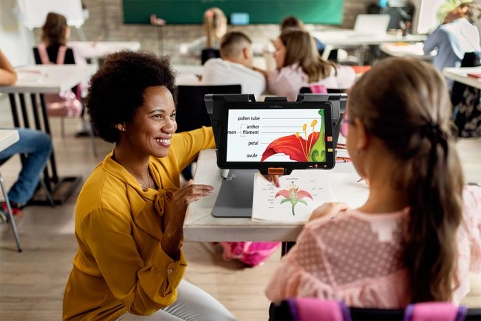 student using humanware connect 12 in classroom environment for reading and learning with visual impairment support